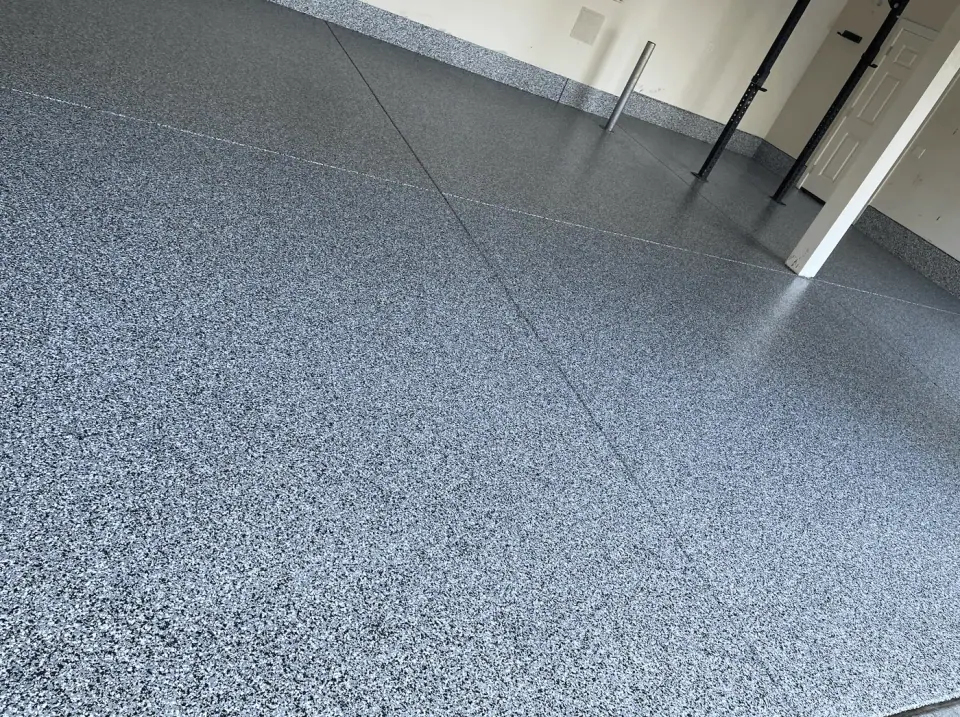 Close-up detail of blue granite flake polyaspartic coating