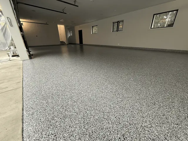 New-construction Seattle-area garage with an ash flake floor and high windows