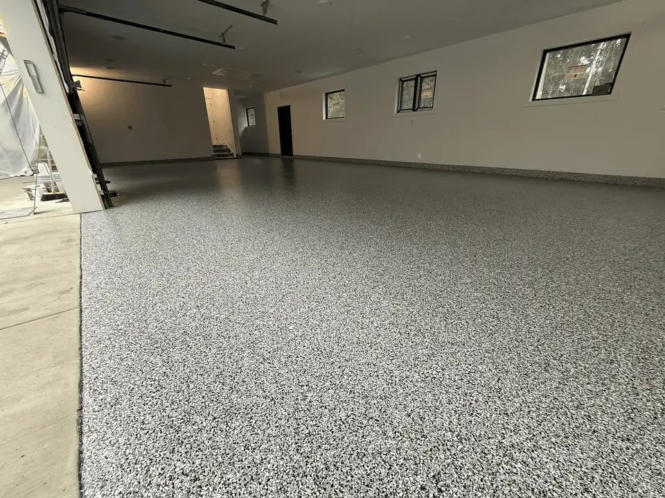 Large garage with a clean, glossy ash flake epoxy-style floor coating
