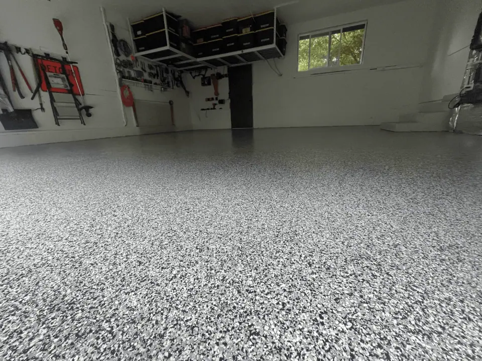 Professional silver flake coating in a workshop garage