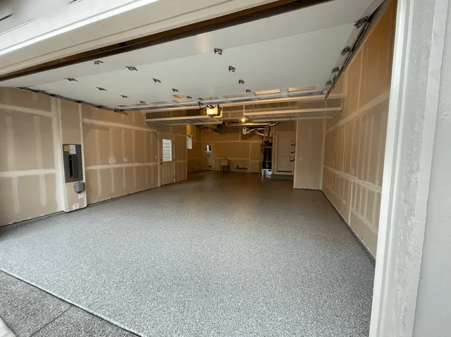 Deep Seattle-area garage with a dove gray flake floor, seen from the driveway