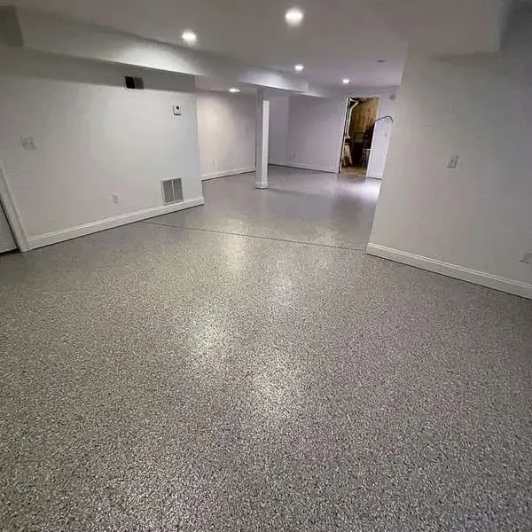 Large finished basement with white walls and a gray flake floor