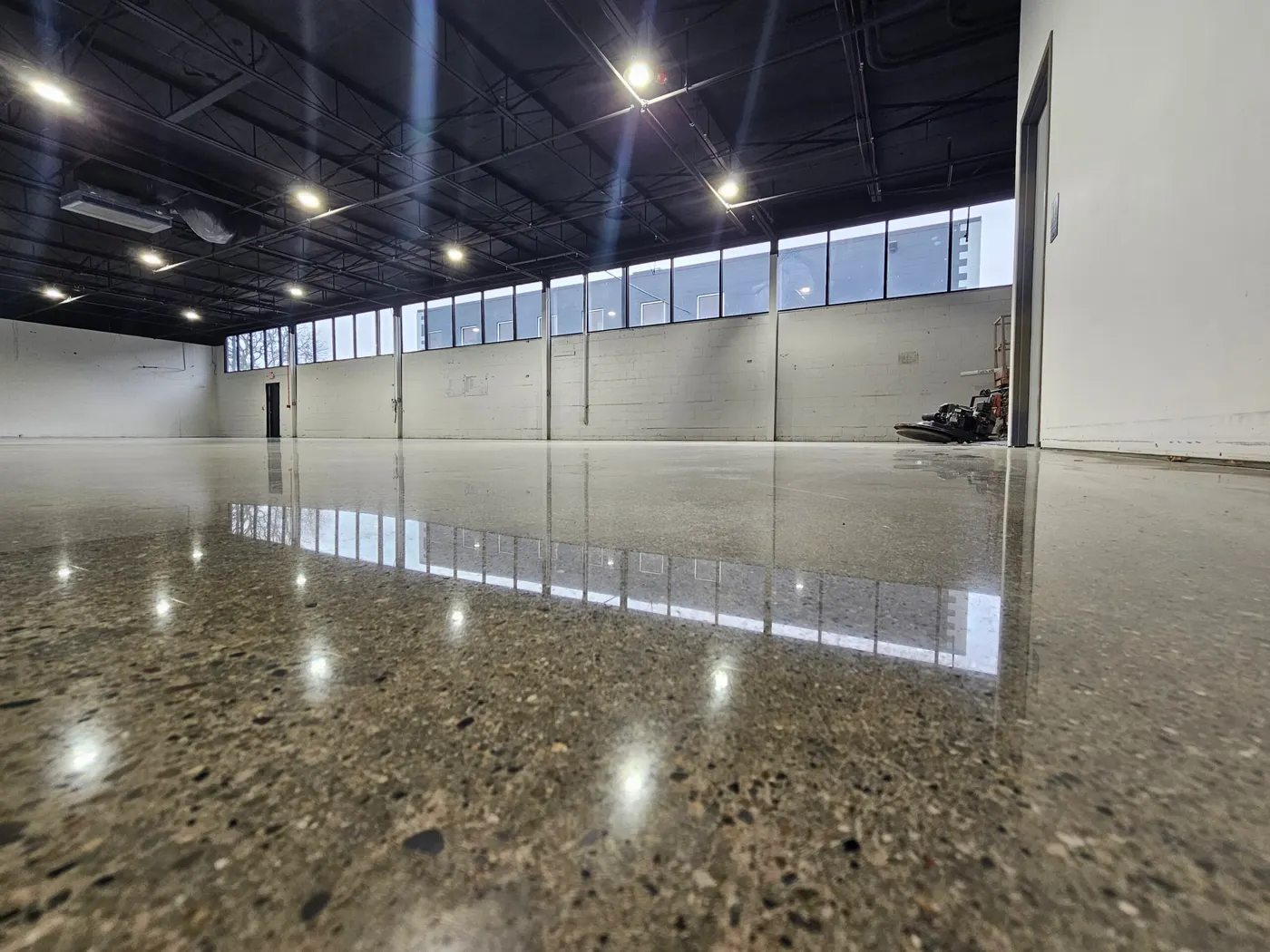 Polished concrete floor with exposed aggregate in an empty commercial building