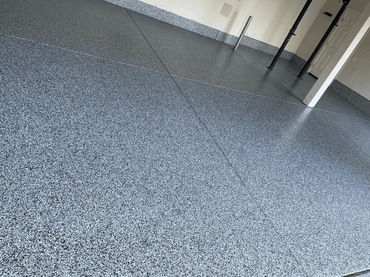 Close-up of a blue granite flake floor coating in a Seattle-area garage