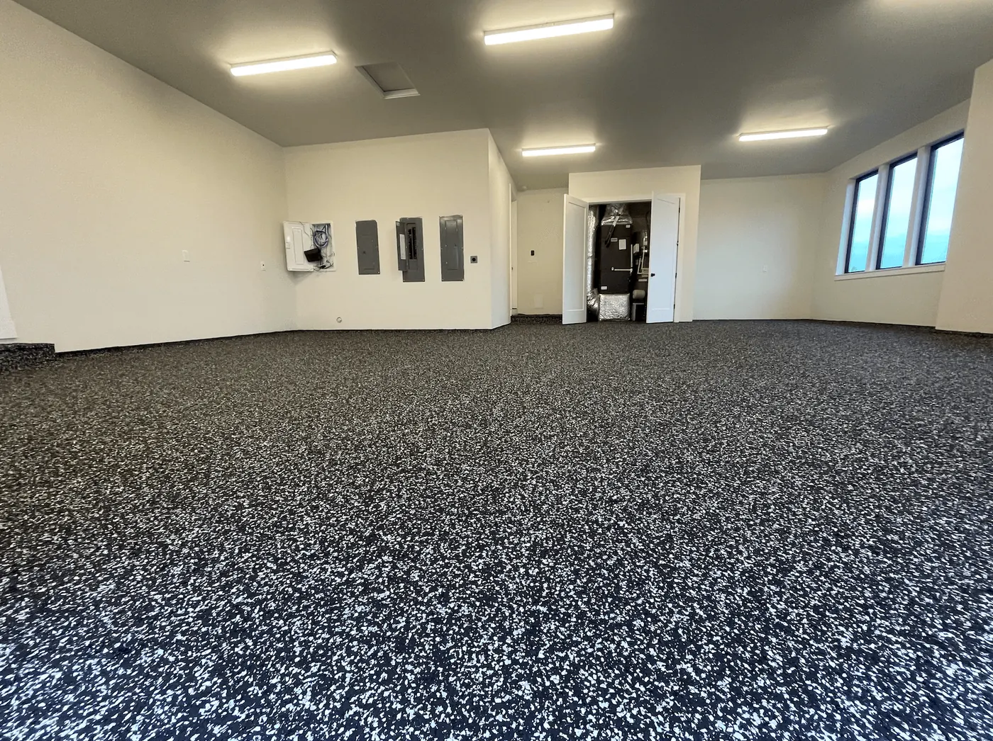 Seattle-area garage with a black and white domino flake floor