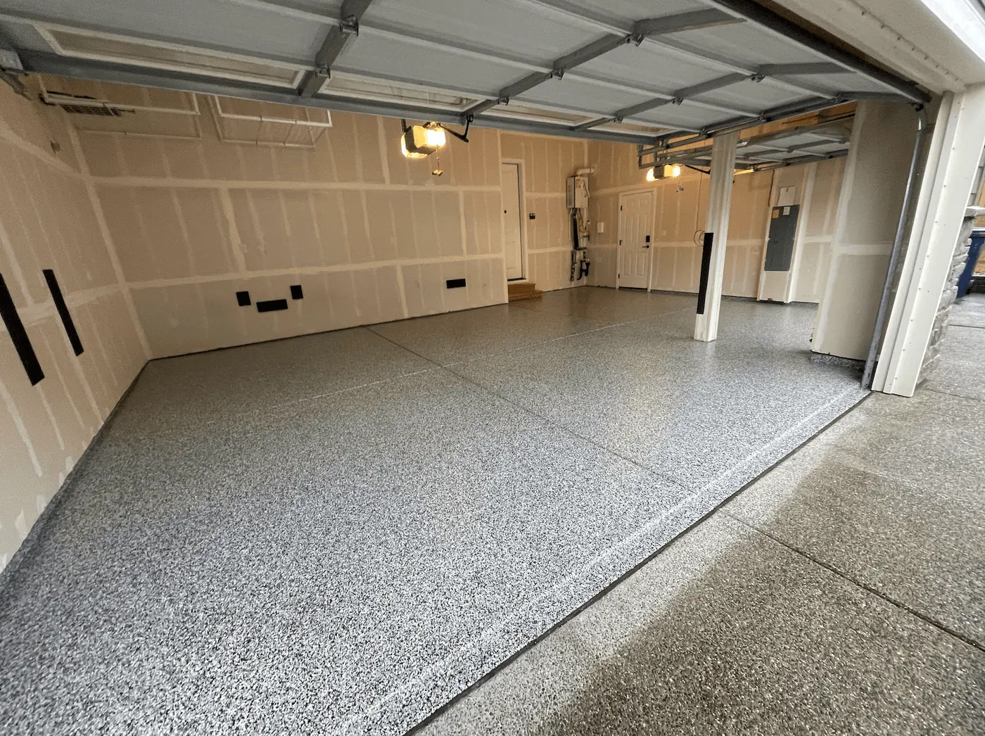Dove gray flake floor across a multi-bay Seattle-area garage under raised doors
