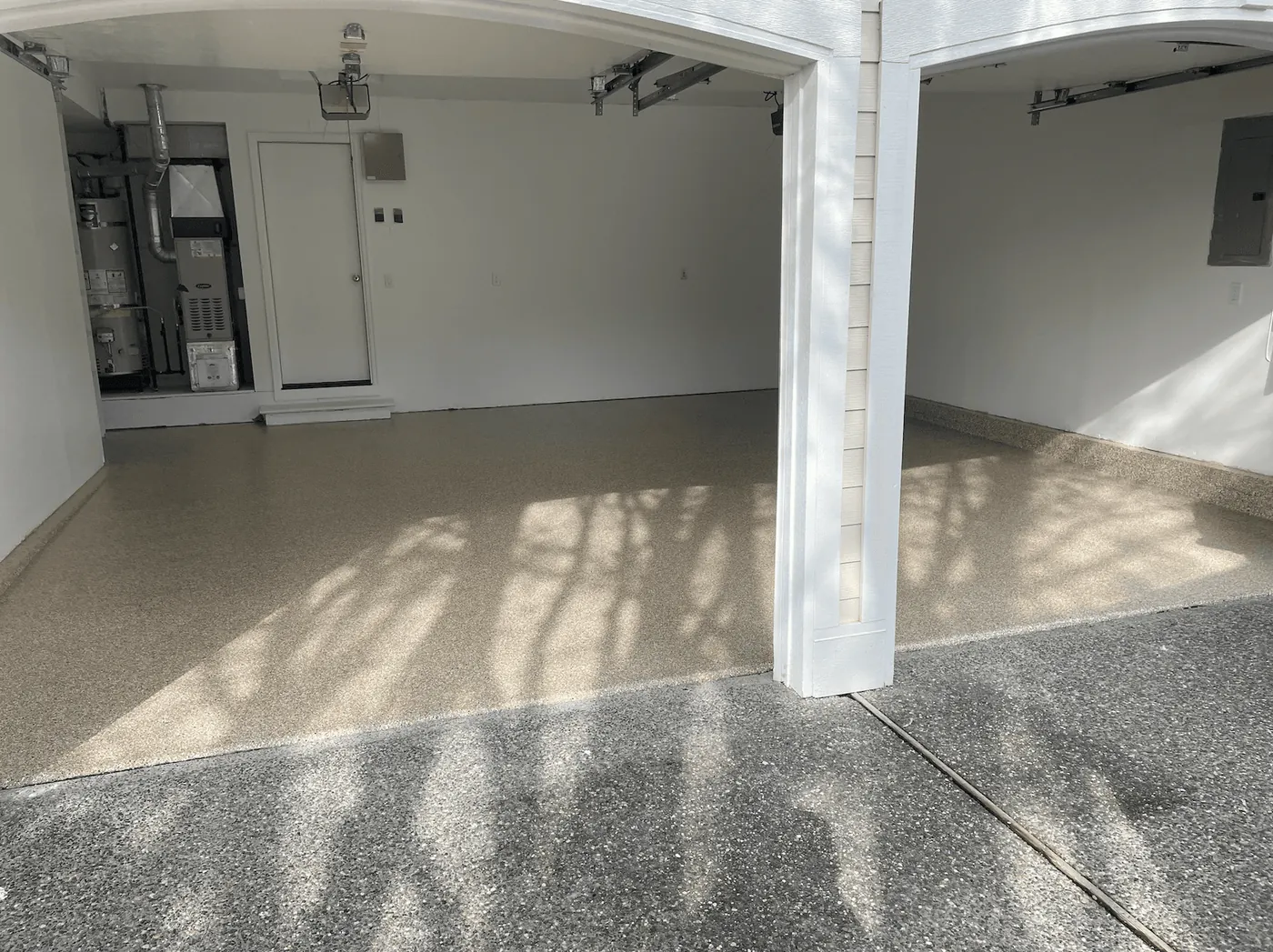 Sandstone flake floor seen through the two arched garage door openings of a Seattle-area home