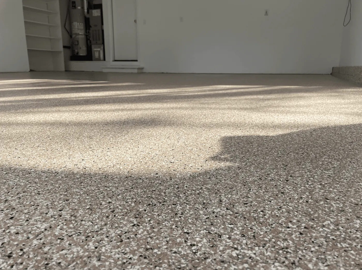 Close-up of a sandstone flake garage floor coating