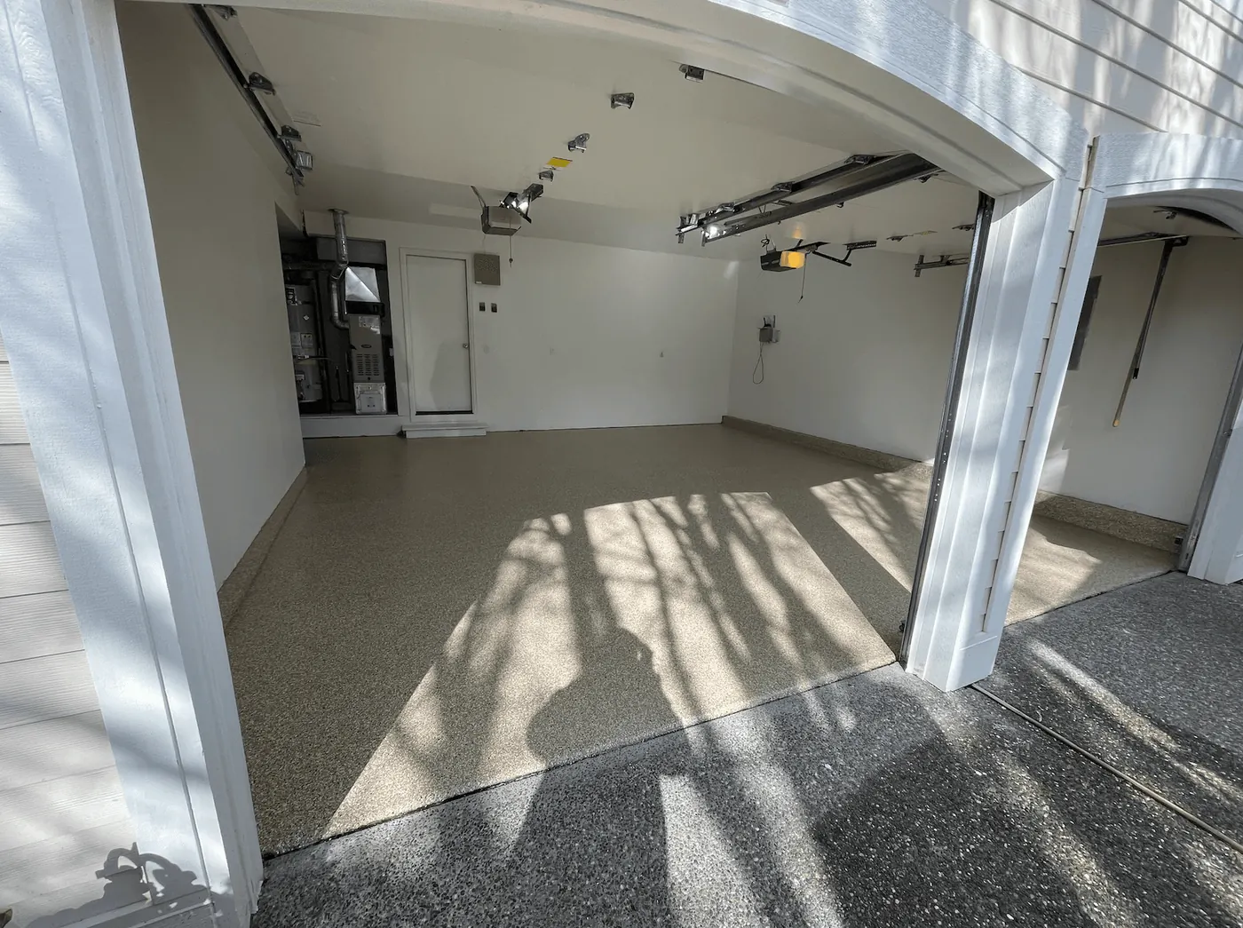 Sandstone flake floor in a Seattle-area garage, with the furnace and water heater in the back corner