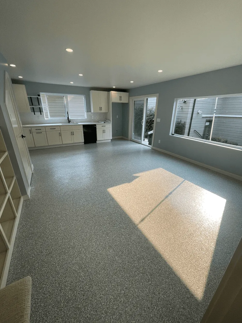 Residential great room with a gray flake floor coating