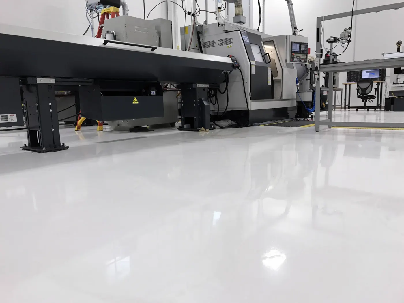 CNC machine shop with a bright light gray gloss floor