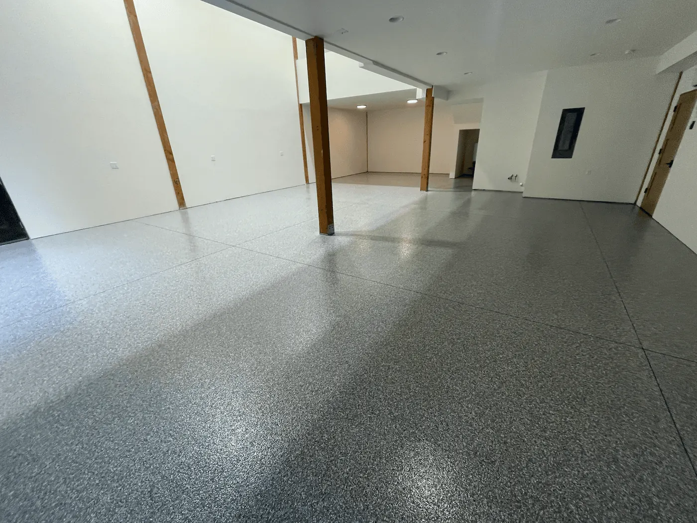 Granite flake floor around wood support posts in an open Seattle-area shop
