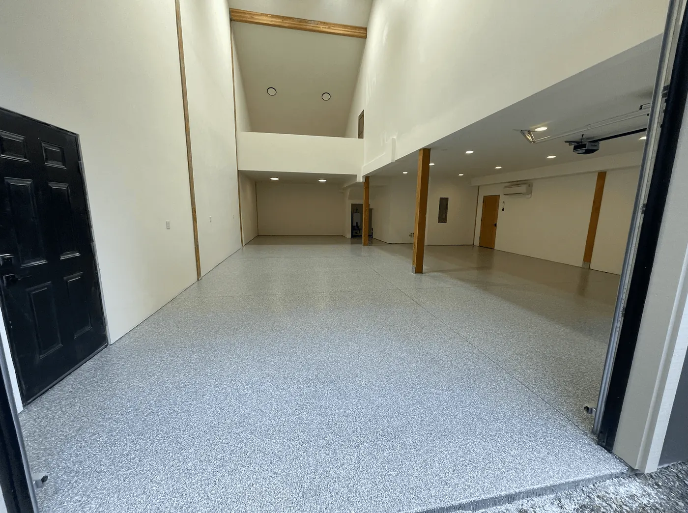 Open Seattle-area shop with a granite flake floor, seen through a black entry door