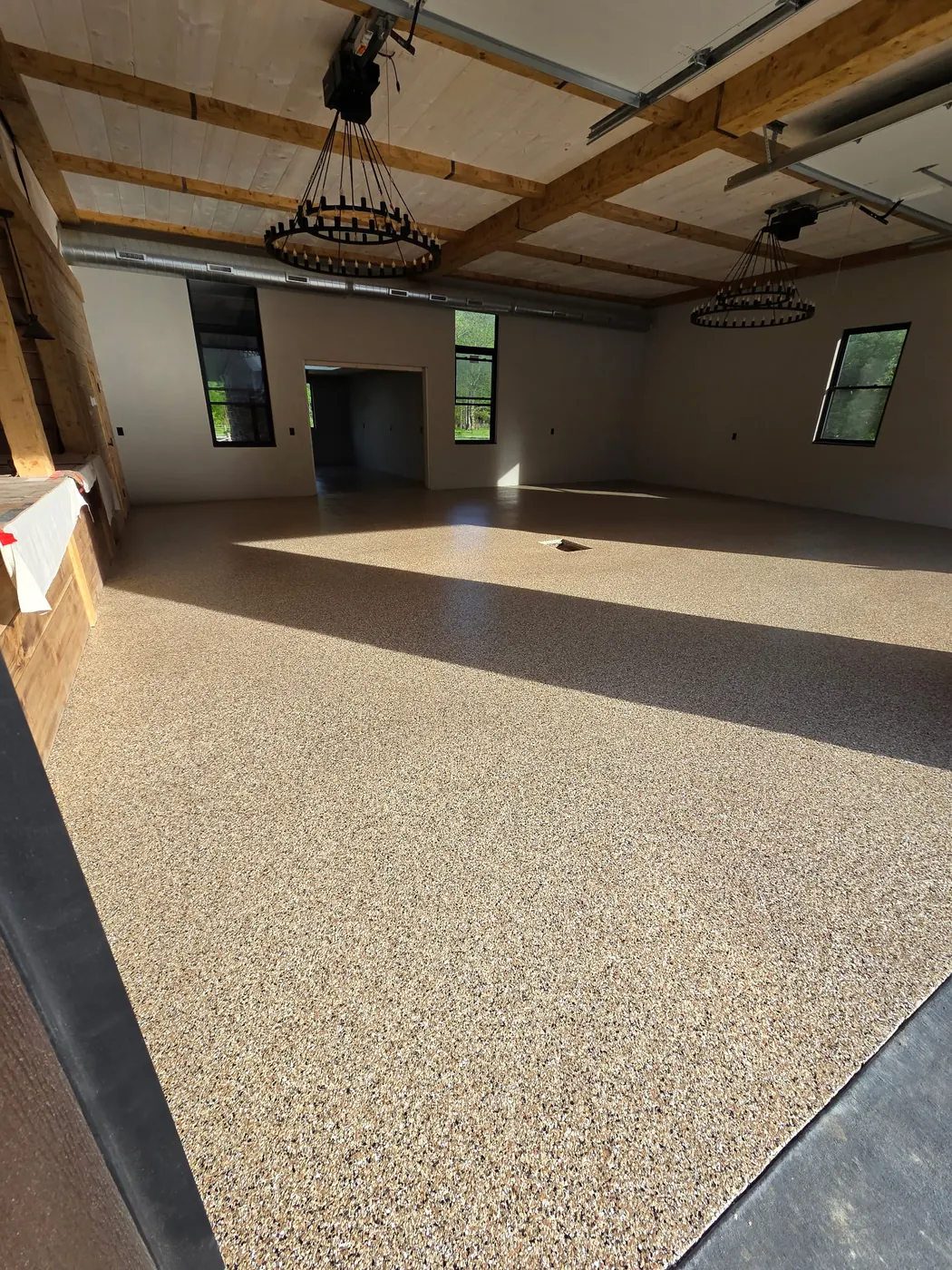 Finished residential great room with sandstone flake floor coating