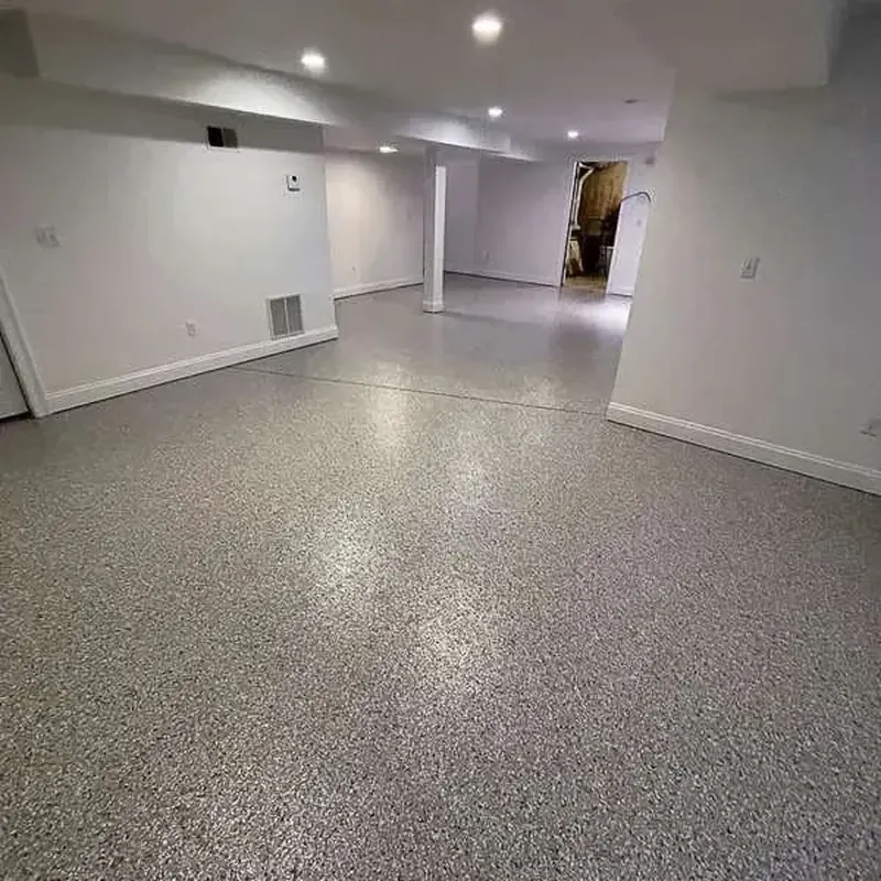 Large finished basement with white walls and a gray flake floor