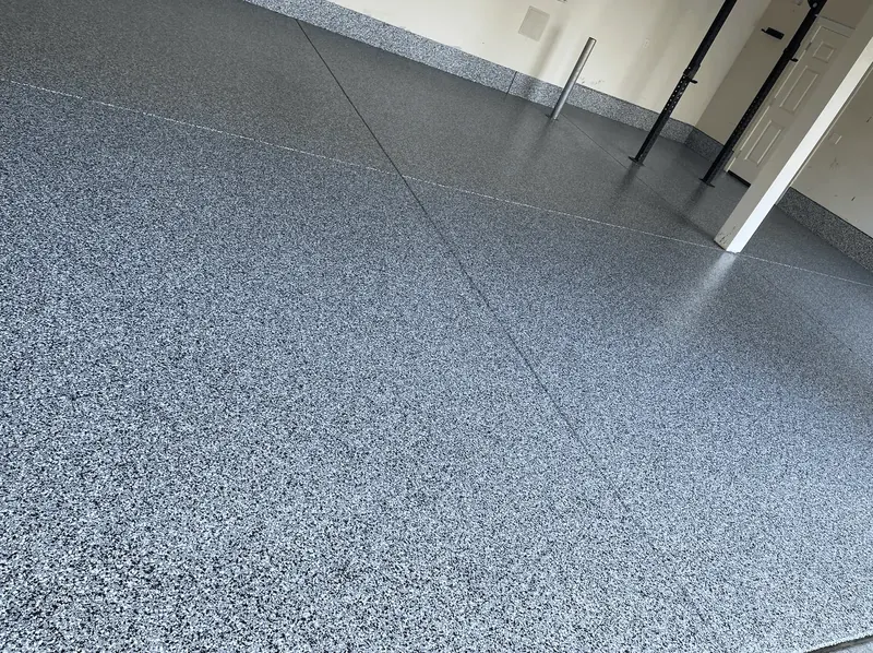 Close-up of a blue granite flake floor coating in a Seattle-area garage