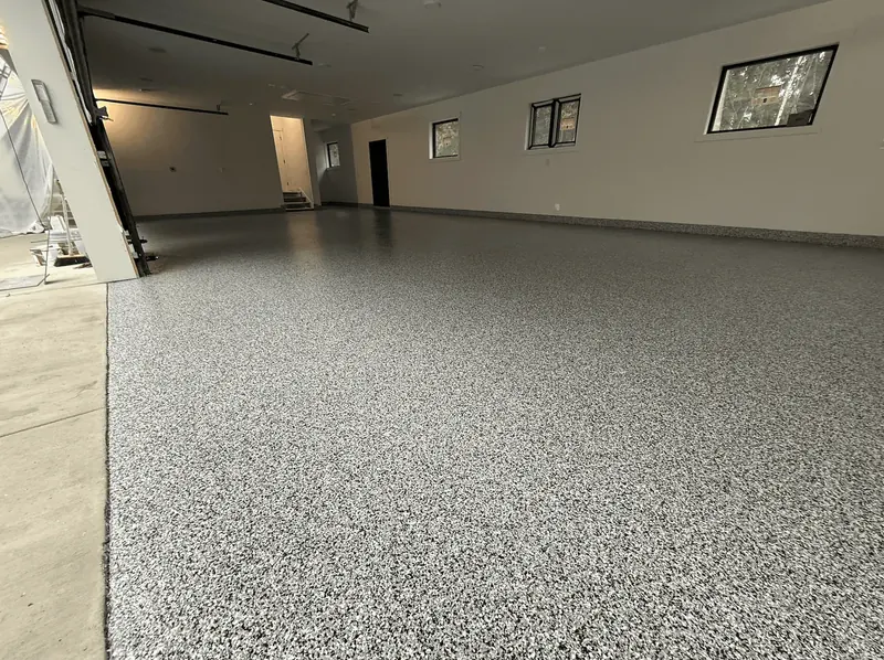 New-construction Seattle-area garage with an ash flake floor and high windows