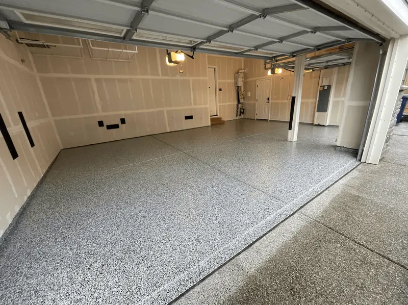 Dove gray flake floor across a multi-bay garage under raised doors