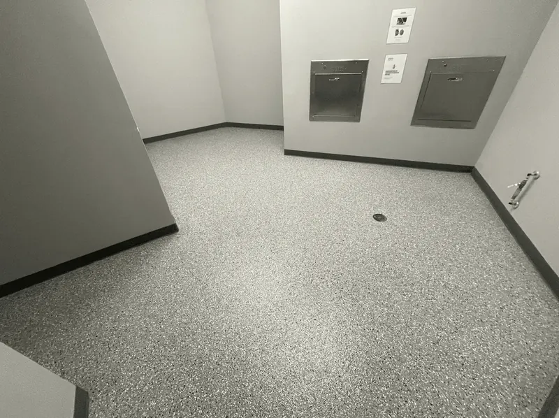 Lower-level room with a mist gray flake floor coating