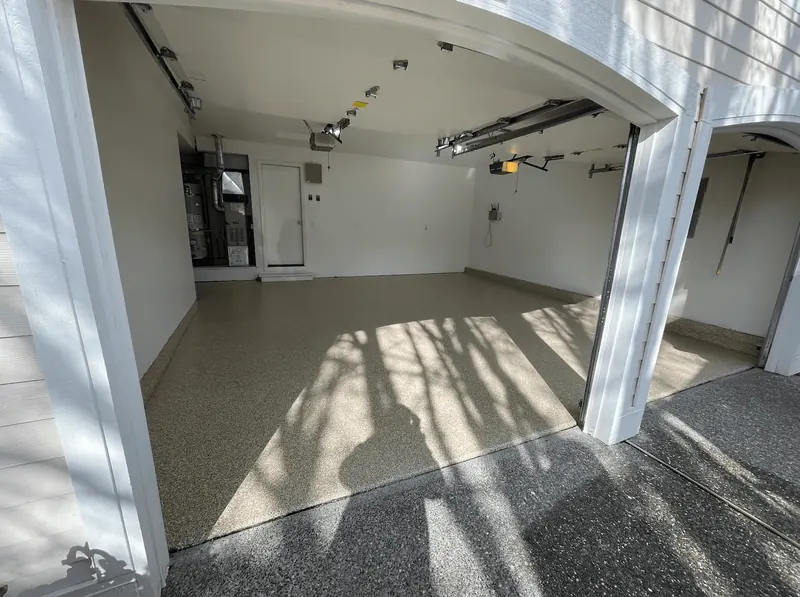Sandstone flake floor in a garage, with the furnace and water heater in the back corner