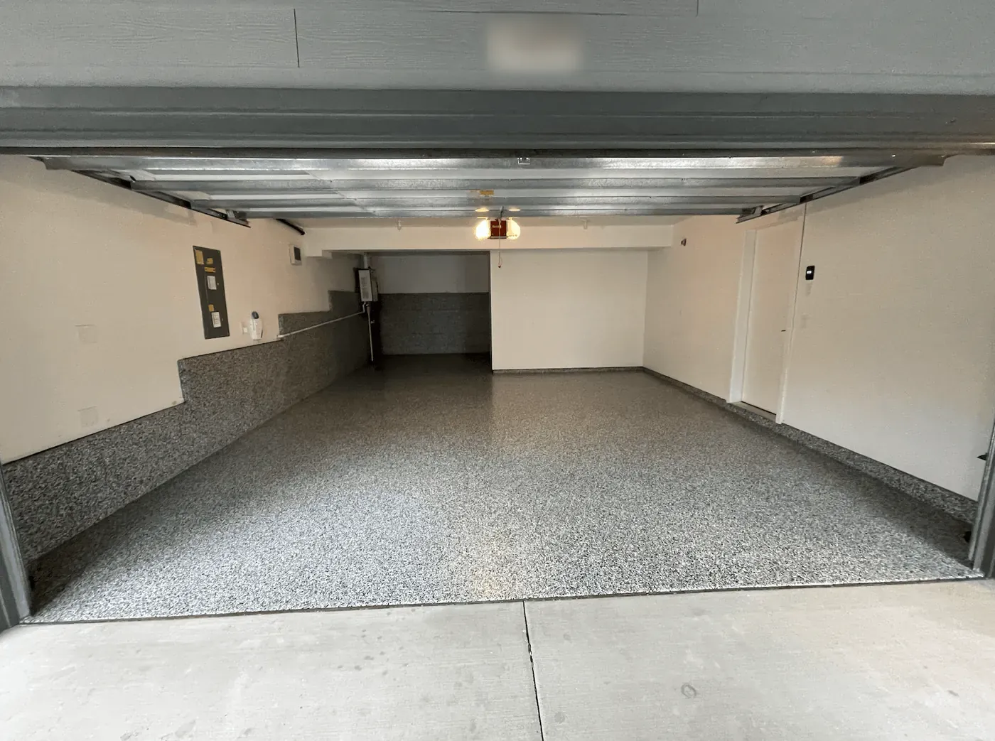 Deep Seattle-area garage with a pewter flake floor and flake-coated stem walls