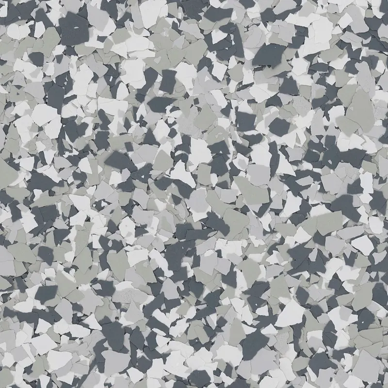 Close-up of quarter-inch vinyl flake chips in the Gravel blend: light gray, white and dark gray